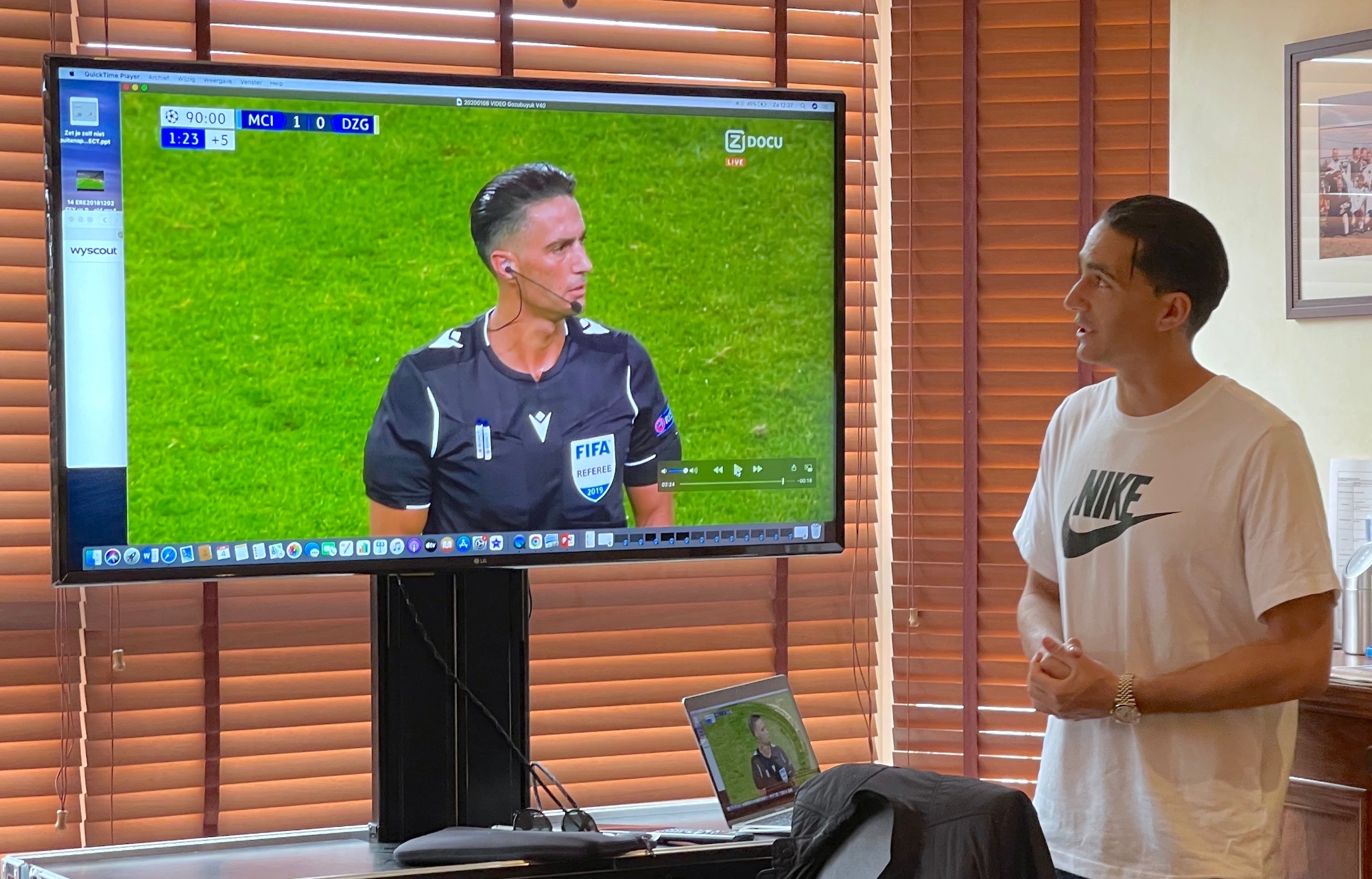 Serdar discussing match footage on a big screen